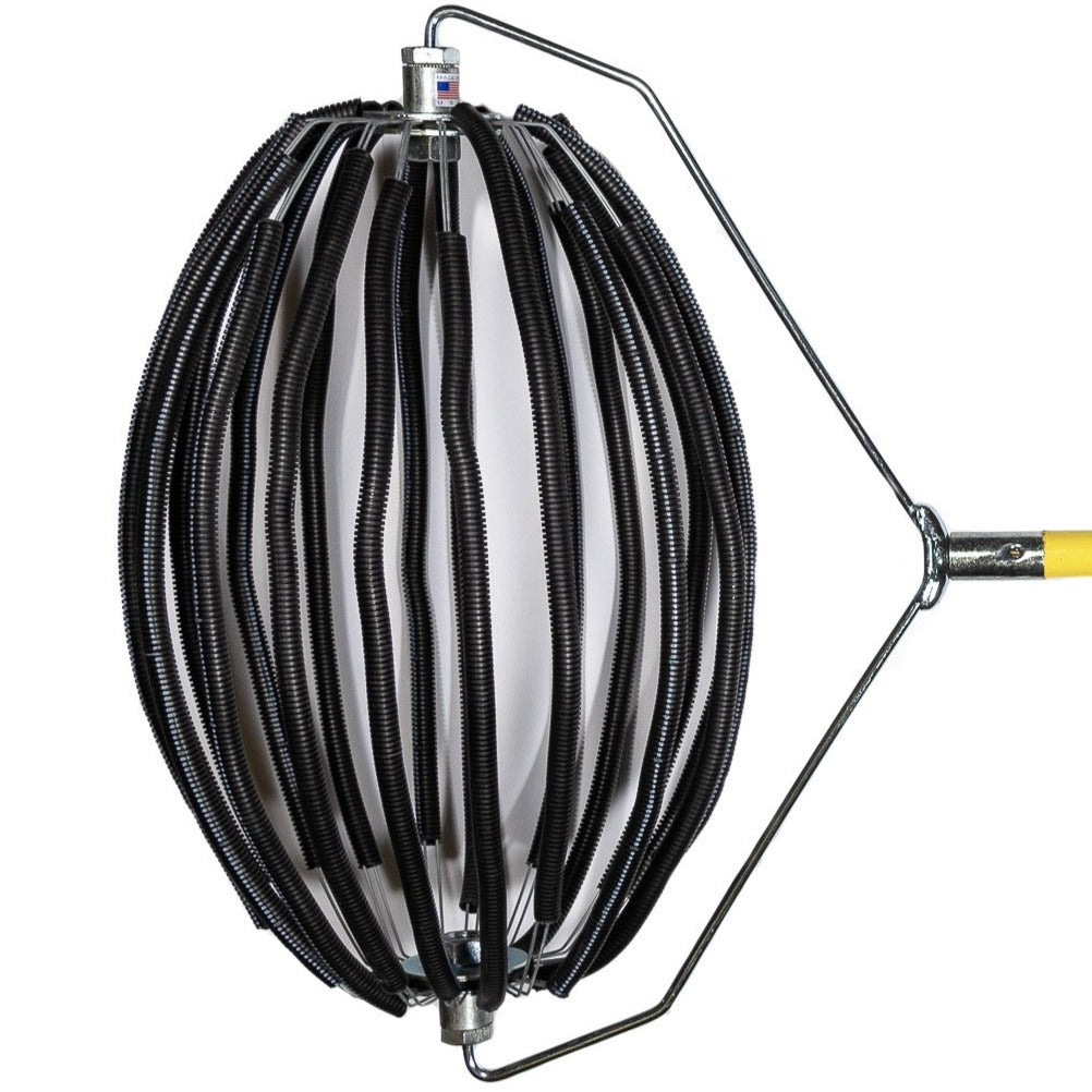 An Extra-Large Nut Wizard® with its many wires covered in black-ribbed rubber tubing that are held together with metal plates to create a "basket,"; The plates have two large bolts sticking out on either end. The bolts are attached to a “bail,” a thin metal wire-type part bent in six points with a threaded piece in the center that attaches the Nut Wizard® basket to a yellow, four-foot wooden handle.