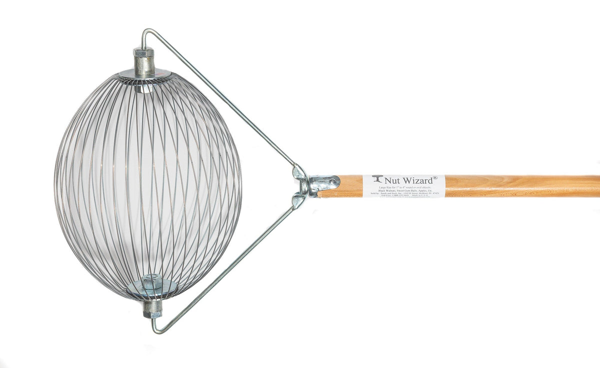 A Large Nut Wizard® with its many wires that are held together with metal plates to create a "basket,"; The plates have two large bolts sticking out on either end. The bolts are attached to a “bail,” a thin metal wire-type part bent in three points with a threaded piece in the center that attaches the Nut Wizard® basket to a pine, four-foot wooden handle. The handle has a white label with a tree and the words "Nut Wizard®" on it.