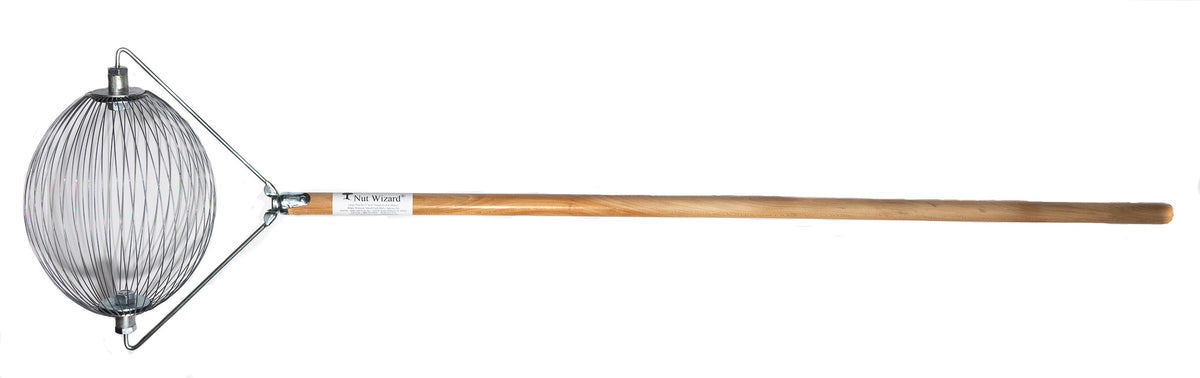 A Large Nut Wizard® with its many wires that are held together with metal plates to create a "basket,"; The plates have two large bolts sticking out on either end. The bolts are attached to a “bail,” a thin metal wire-type part bent in three points with a threaded piece in the center that attaches the Nut Wizard® basket to a pine, four-foot wooden handle. The handle has a white label with a tree and the words "Nut Wizard®" on it.