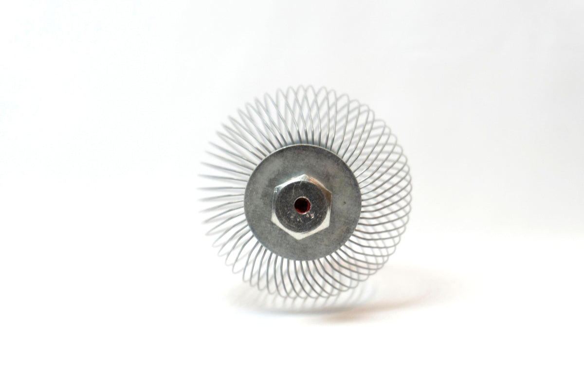 A Nut Wizard basket with many thin wires are held together with metal plates to create a "basket" with two large bolts sticking out on either end.