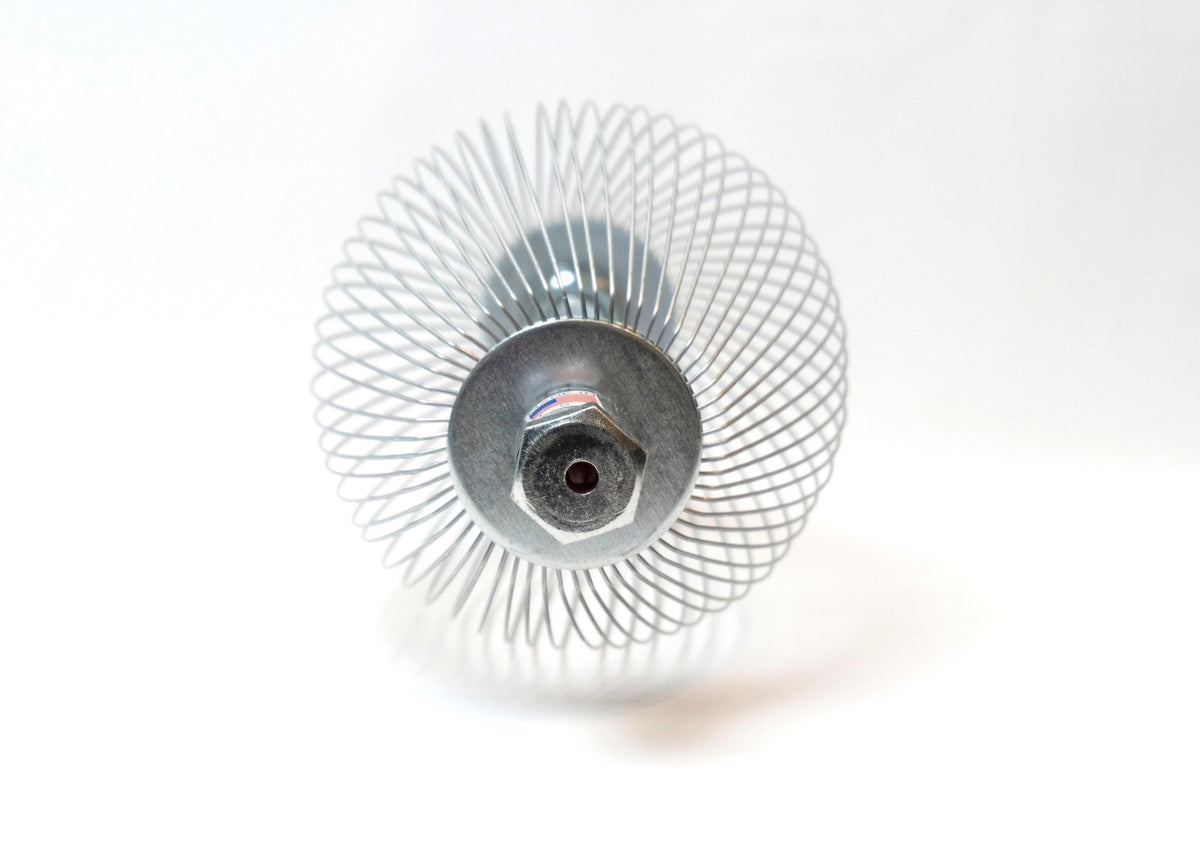 A Nut Wizard basket with many thin wires are held together with metal plates to create a "basket" with two large bolts sticking out on either end. A sticker on one bolt shows an American flag and the words "Made in the USA."